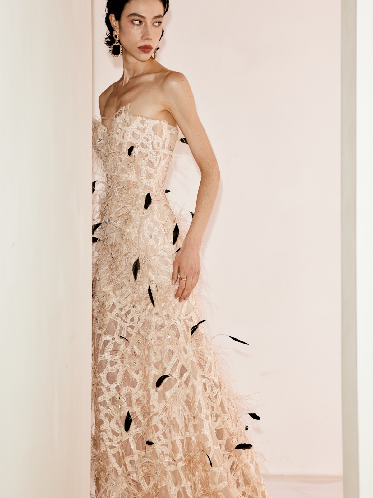 A bride in a feather gown in Lichée Bridal's pale San Francisco fitting room