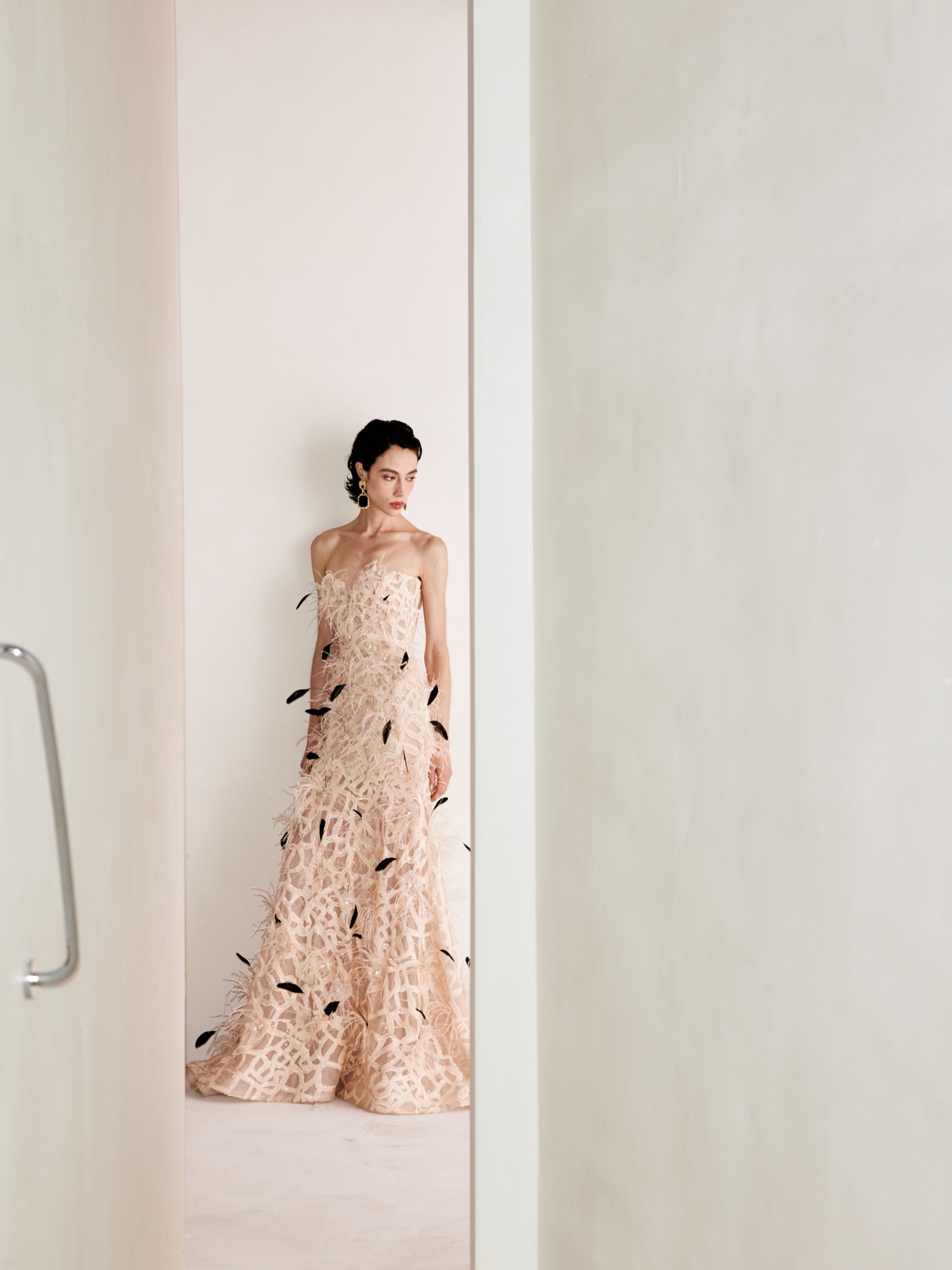 Lichée Bridal bride in a feather-embellished gown in a pale San Francisco studio