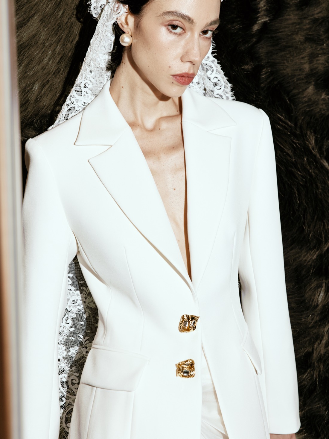 Lichée Bridal SS26 — white suit with gold buttons, editorial close-up